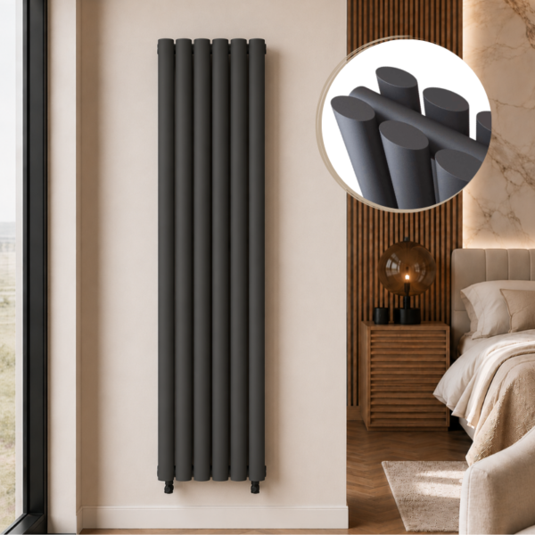 Alma Double Oval Vertical Designer Radiator 1600x360mm Anthracite installed in a luxury modern bedroom interior with close-up inset highlighting the smooth oval tube design.