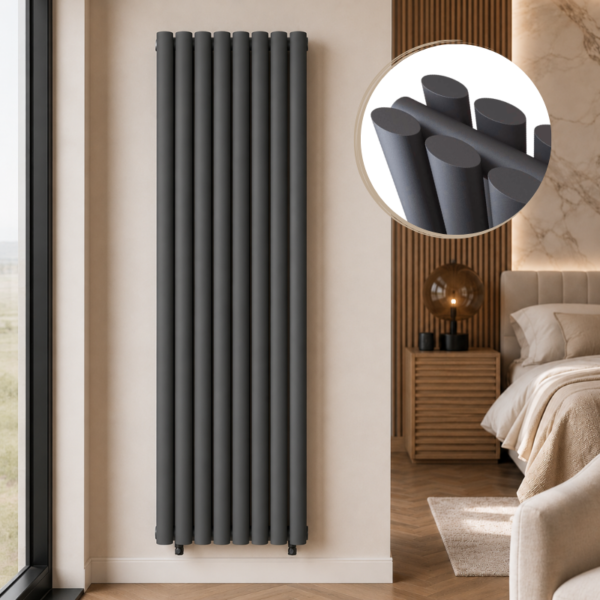Alma Double Oval Vertical Designer Radiator 1600x480mm Anthracite installed in a luxury modern bedroom interior with close-up inset highlighting the smooth oval tube design.