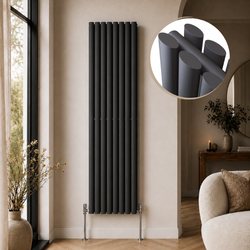 Alma Double Oval Vertical Designer Radiator 1600mm x 360mm in Anthracite installed in a modern beige living room with herringbone flooring and contemporary décor.