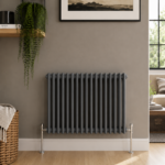 Aura 2 Column Horizontal Radiator 600x830mm Anthracite installed in a modern living space with wooden flooring and neutral décor.