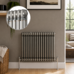 Aura 2 Column Horizontal Radiator 600x830mm Raw Metal installed in a modern living space with close-up inset highlighting the premium raw metal finish.