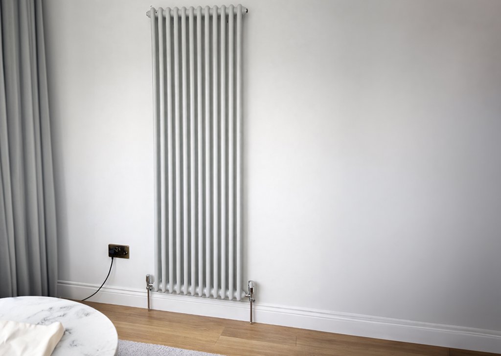 Vertical white column radiator installed by Croston Plumbing and Heating, supplied by The Radiator Hub