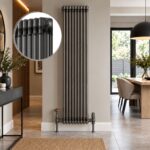 Aura 3 column vertical radiator, 1800mm x 425mm, in a raw metal finish installed in a modern dining room.