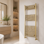 Vela brushed brass designer towel radiator 1200mm x 500mm installed in a modern luxury bathroom