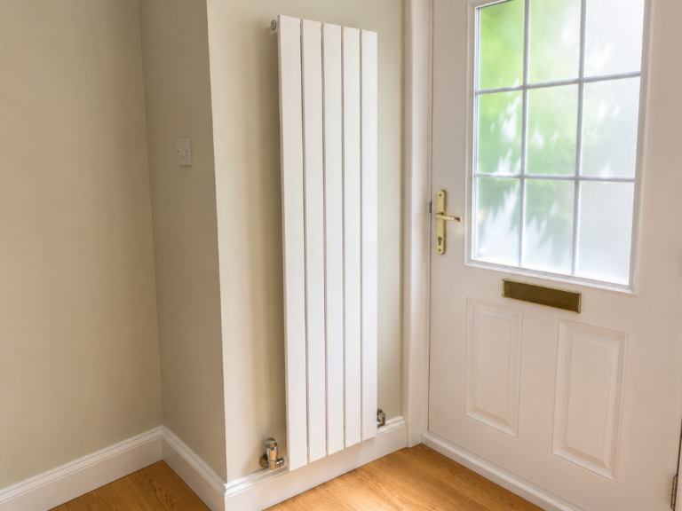 Customer installed Luna Single Flat Vertical Designer Radiator 1600mm x 376mm White in a modern hallway beside the front door.